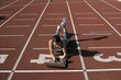 © STOCK4B  - Woman lying with a laptop on a running track