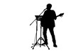 Isolated man singing and playing guitar with note stand and microphone with clipping path