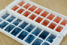 Red And Blue Ice Cubes In White Ice Trays For July 4th Independence Day