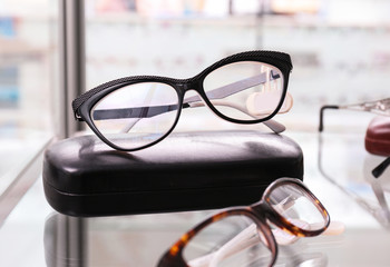 Poster - Shelf with glasses and spectacle-case in shop