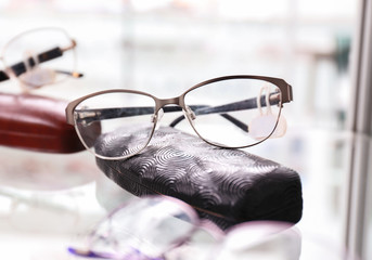 Wall Mural - Shelf with glasses and spectacle-case in shop