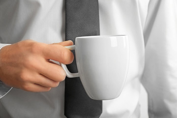 Wall Mural - Man holding blank cup, closeup