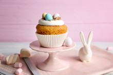 Cake Stand With Delicious Easter Cupcake On Wooden Table