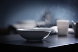 Fototapeta  - Steam over bowl on kitchen table