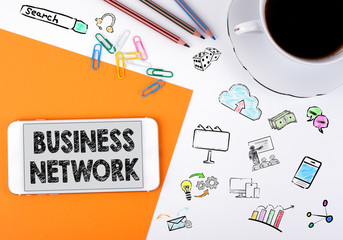 Wall Mural - business network concept. mobile phone and coffee cup on a white office desk.