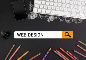Wall Mural - web design concept. colorful pencils and a computer keyboard with a mobile phone on a black table.