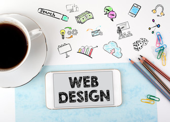 Wall Mural - web design concept. mobile phone and coffee cup on a white office desk.
