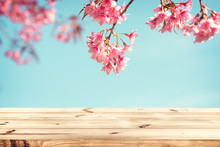 Top Of Wood Table Empty Ready For Your Product And Food Display Or Montage With Pink Cherry Blossom Flower (sakura) On Sky Background In Spring Season. Vintage Color Tone.