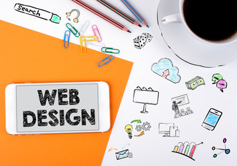 Canvas Print - web design concept. Mobile phone and coffee cup on a white office desk.