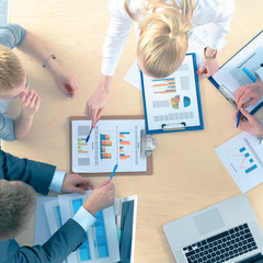 Business people sitting and discussing at business meeting, in office