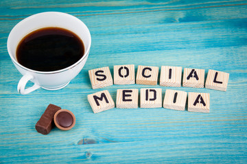 Wall Mural - social media. Coffee mug and wooden letters on wooden background.