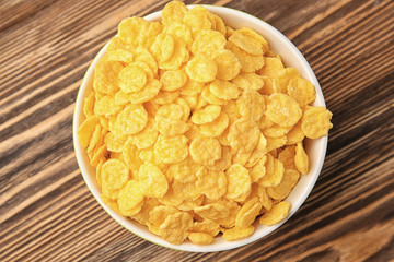 Wall Mural - Bowl with cornflakes on wooden background