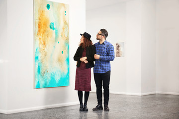 Young couple in modern art gallery