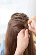 © Africa Studio - Hairdresser making braid hairstyle to young beautiful woman, closeup