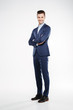 © Drobot Dean - Full length image of smiling business man with crossed arms