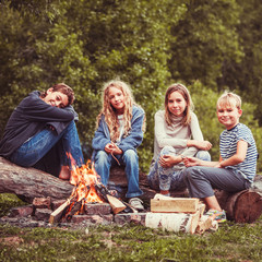 children in the camp by the fire