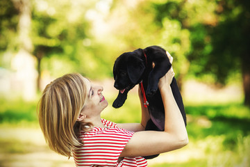 Girl with labrador puppy