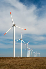 wind turbines against a blue sky generating electricity