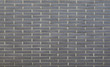 Warm grey brick wall texture background. Tiled