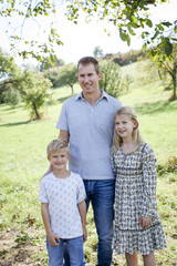 Wall Mural - happy father with 2 children outdoors