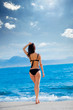 © Masson - beautiful young woman standing in front of wonderful sea background in Greece