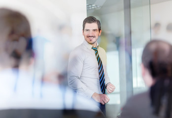 Wall Mural - Relaxed cheerful team leader and business owner leading informal in-house business meeting. Business and entrepreneurship concept.