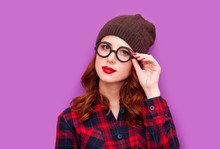 Beautiful Young Woman Standing In Hipster Glasses On The Wonderful Purple Background