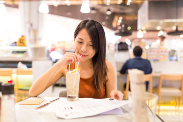 Poster - Woman enjoy her drink in restaurant