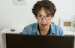 © Philipimage - woman with eyeglasses websurfing on laptop
