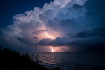 Strike of lightning from big beautiful cloud after storm