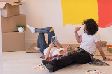 Wall Mural - Happy young couple relaxing after painting