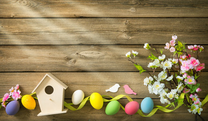 Wall Mural - Easter background with colorful eggs and spring flowers