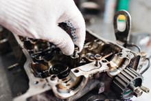 Engine Crankshaft, Valve Cover, Pistons. Mechanic Repairman At Automobile Car Engine Maintenance Repair Work