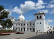 A blue sky day above the beautiful large white Torre del Reloj in the central plaza of Popayan 