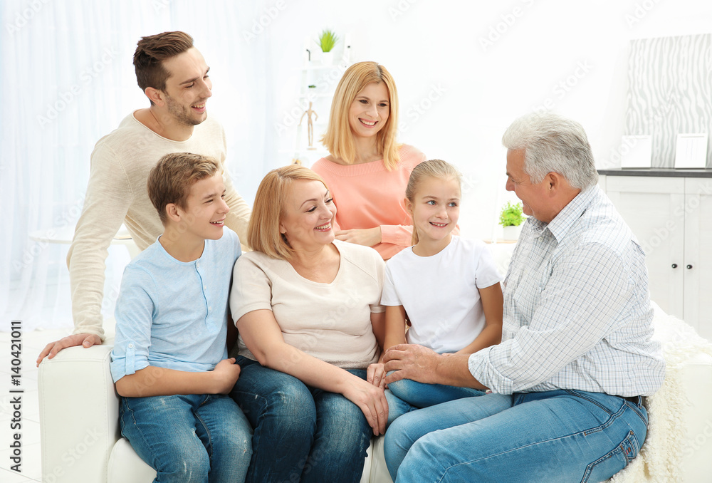 Happy family sitting on sofa in living room