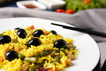 Wall Mural - Tasty rice with vegetables and olives on plate