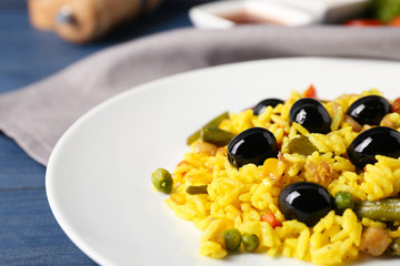 Wall Mural - Tasty rice with vegetables and olives on plate