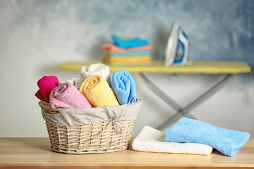 Wall Mural - Flasket of clean towels on table