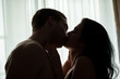 © DenisProduction.com - Couple kissing in the darkness. Man with woman indoor. Don't restrain passion.