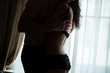 © DenisProduction.com - Man hugging woman in lingerie. Couple near room window. Touch by touch.