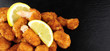Breadcrumb Covered Fried Scampi On Slate Background