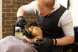 Male client having beard haircut at barbershop