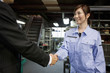 © amanaimages - Young Woman Shaking Boss'S Hand