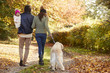 © Monkey Business - Family With Daughter And Dog Enjoy Autumn Countryside Walk