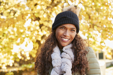 Wall Mural - Outdoor Portrait Of Smiling Woman Wearing Scarf In Autumn