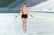 © veles_studio - Girl jumping on skipping rope on stadium