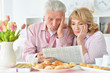 © aletia2011 - Elderly couple having breakfast and reading a newspaper
