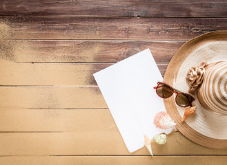 Wall Mural - Empty white note paper and Sea sand with Straw hat,sunglasses on wooden floor