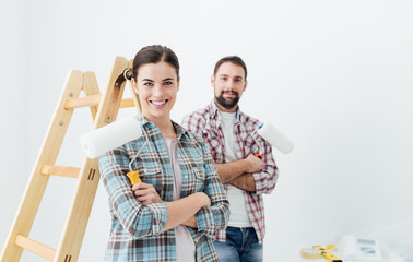 Wall Mural - Happy couple painting their new home