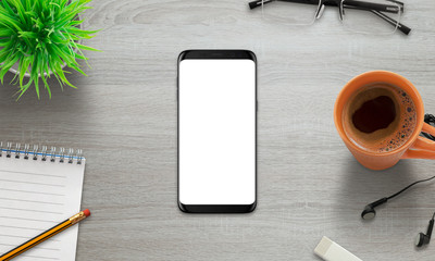Aufkleber - Black modern smart phone with isolated round screen. Isolated screen for mockup. Top view of desk with plant, coffee, pad, pencil, glasses.
